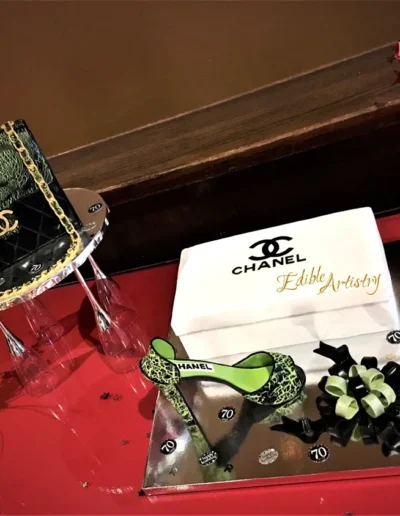 Chanel-inspired luxury cake with designer fashion-themed edible decorations