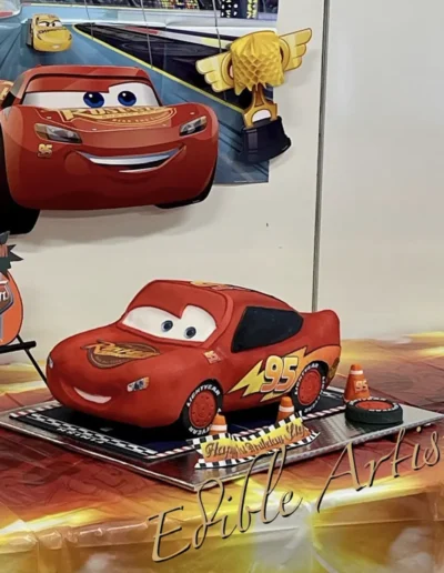 Lightning McQueen character cake with racing-themed edible decorations