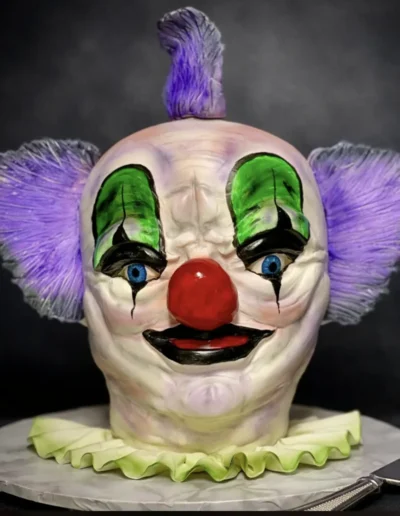 Custom creepy clown head cake with horror-themed edible detailing