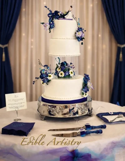 Luxury tiered wedding cake with blue floral accents and modern design