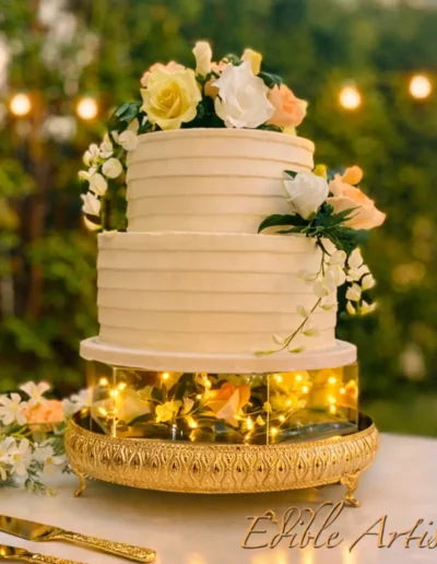 Luxury floral wedding cake with soft white frosting and fresh flower detailing