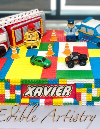 Playful block-themed cake with rescue vehicle details